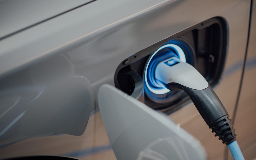 A charger plugged into an Electric Vehicle